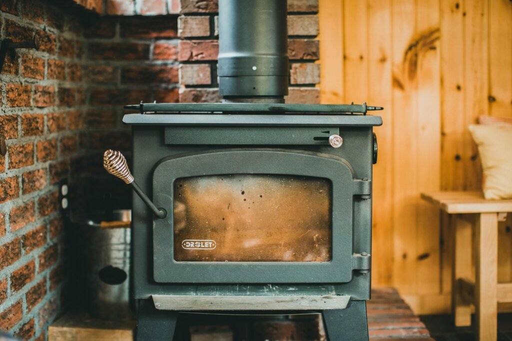 Warm indoor scene with a classic wood stove in a rustic cabin setting, ideal for cozy retreats.